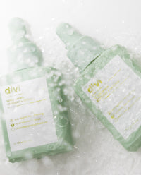 two divi product bottles on wet surface